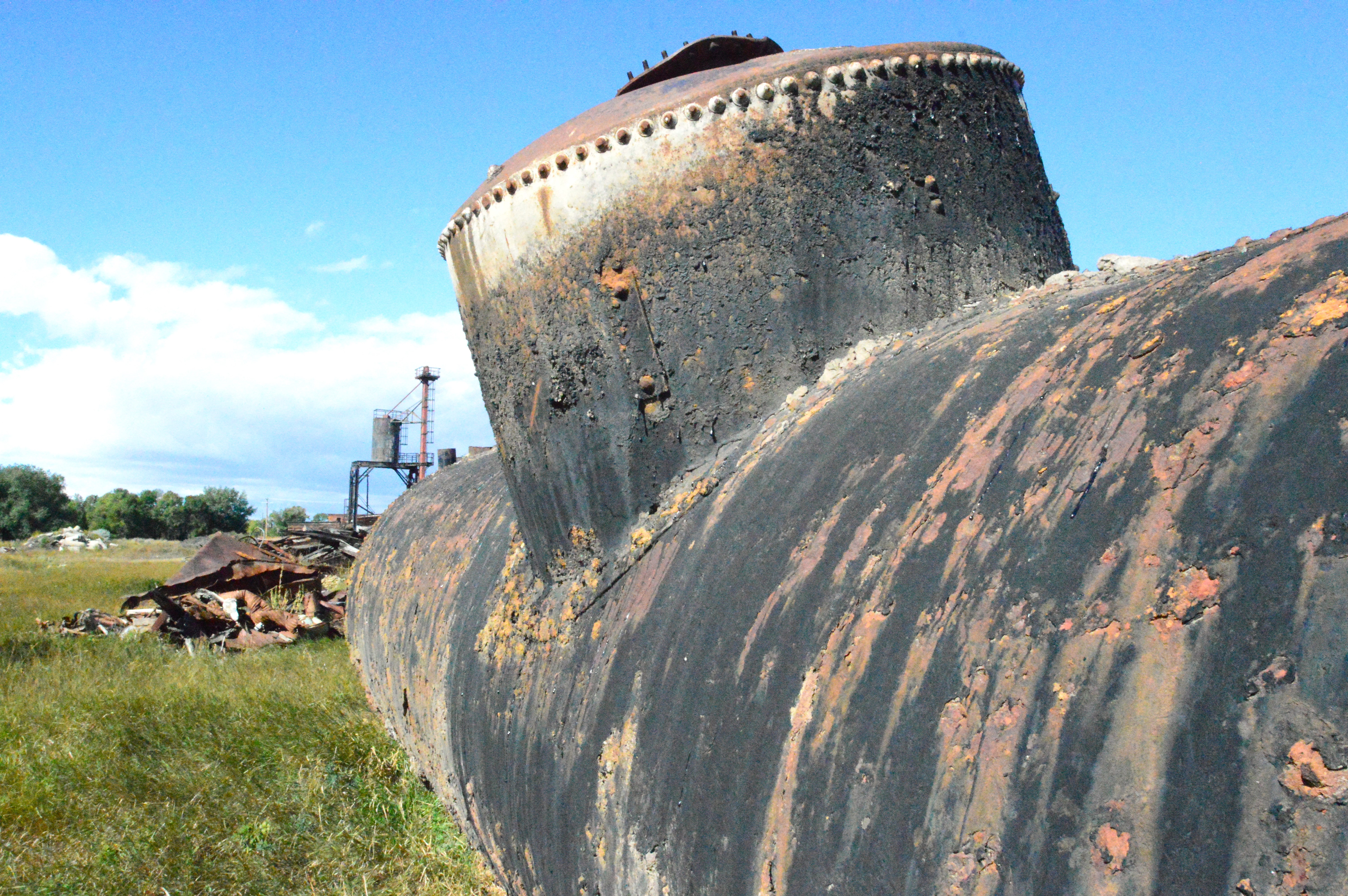 A dilapidated storage tank rests on the former site of the Harlowton Roundhouse in 2024.
